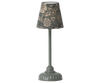 A vintage-style Maileg Farmhouse - Fully Furnished with a floral patterned lampshade and an ornate gray base, set against a plain background in a charming farmhouse setting.