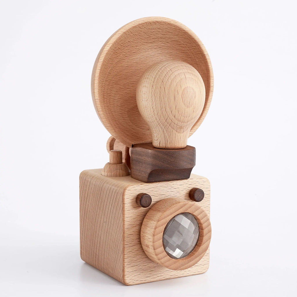 Father’s Factory | Wooden Light Bulb Camera with a simplistic design featuring a round lens and a large viewfinder on top, all set against a white background.