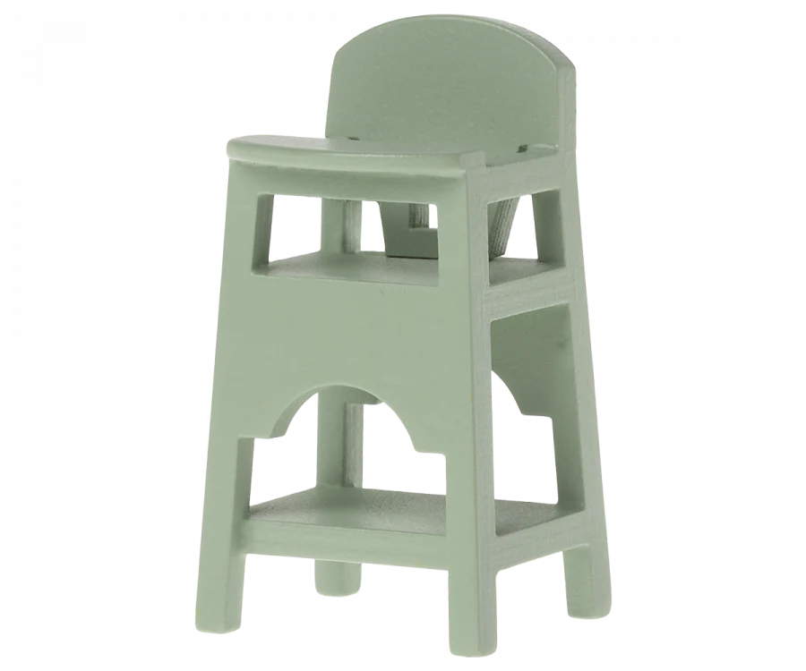 A light green Maileg Mouse Size wooden high chair with back support and footrests, isolated on a gray background.