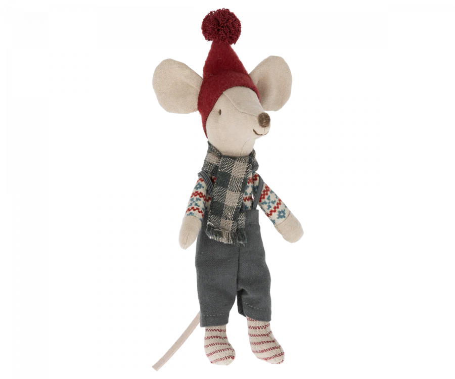 A Maileg Christmas Mouse - Big Brother wearing a red knit hat with a pom-pom, a plaid scarf, gray overalls, and a striped shirt. The mouse has a long tail and is standing upright. With its cozy, winter-themed outfit, this small friend adds festive charm to your seasonal decorations.