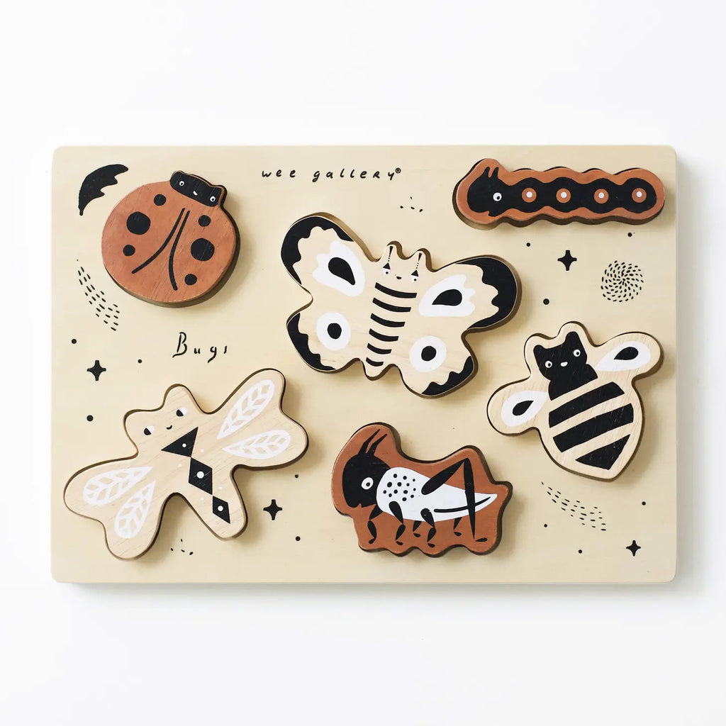 A sustainably sourced Wooden Tray Puzzle - Bugs featuring various bug-shaped pieces including a ladybug, caterpillar, butterfly, bee, dragonfly, and an ant, all designed with cartoonish and friendly expressions.