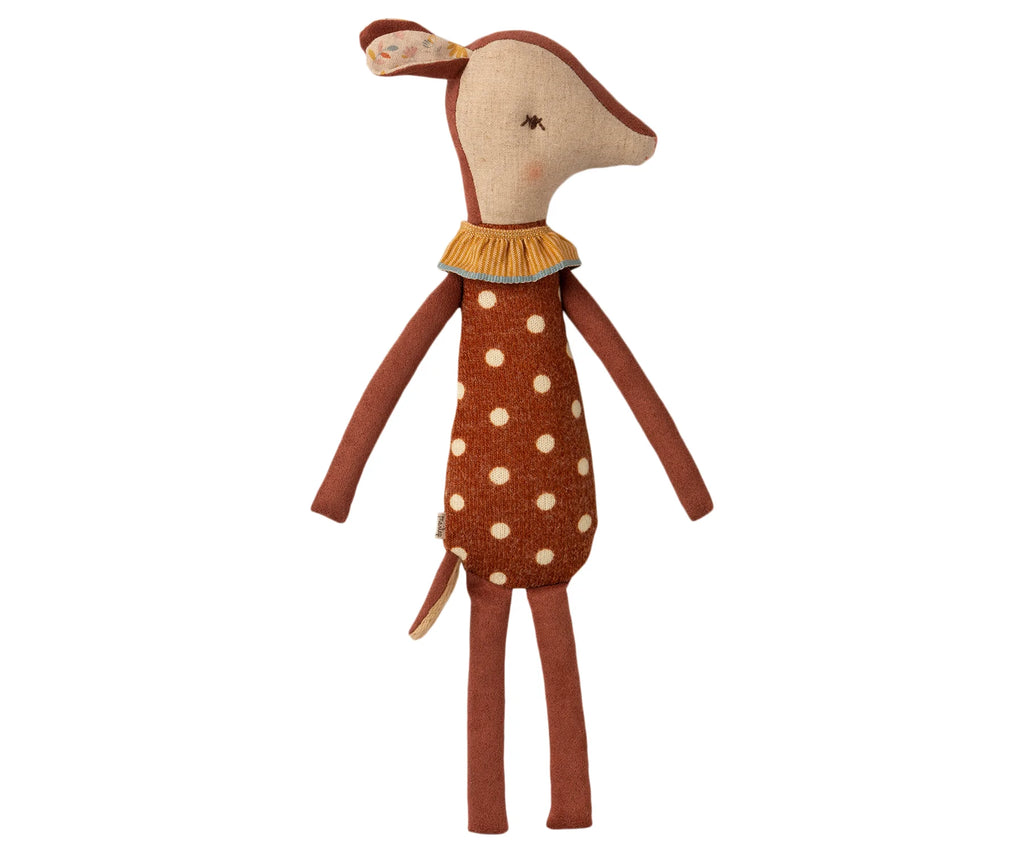 A Maileg Sleep Wakey Bambi Deer stands upright. It has a brown body with cream-colored spots, long legs, arms, and a small tail. The toy has a fabric nose, closed eyes, and wears a small frilled collar around its neck. The 15.75-inch toy's ears are lined with a floral pattern.