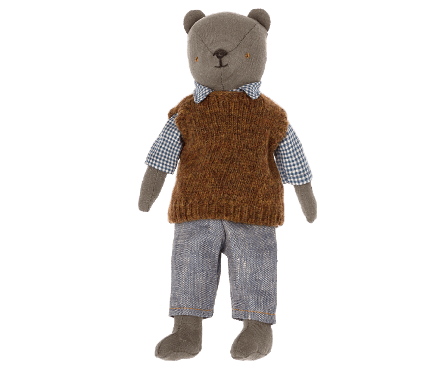 A stuffed bear toy, affectionately known as Teddy Dad, dons a checkered blue and white shirt, a brown knitted vest, and light blue pants. The Maileg Extra Clothing: Shirt, Slipover and Pants for Teddy Dad can also be purchased separately. The bear has a simple facial expression with stitched eyes, nose, and mouth. Its arms and legs are positioned straight.