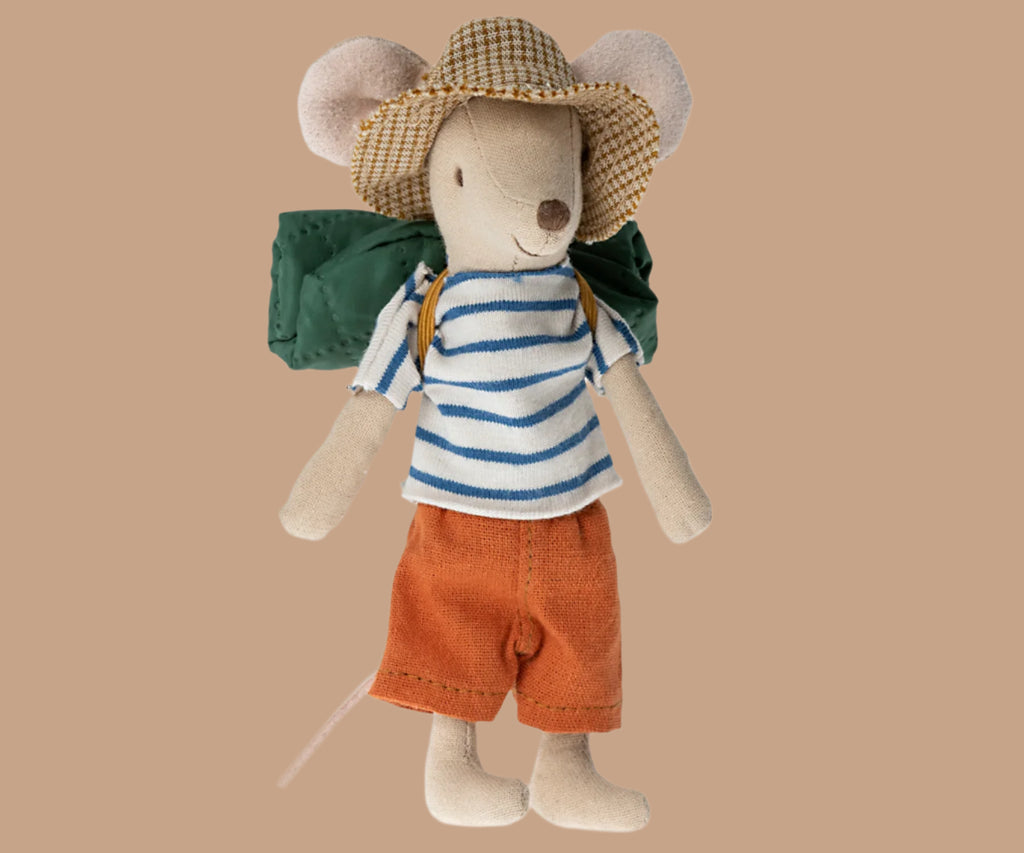 A Maileg Hiker Mouse, Big brother dressed in a striped shirt, durable orange pants, and a checkered hat, equipped with a green backpack, standing upright.