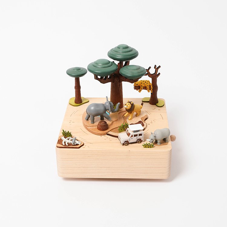Wooden music box with a tree in the middle with African animals. A small wooden jeep going around the music box.