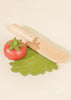Sliceable wooden vegetable toy with a wooden knife.