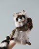 A Raccoon Puppet, artisan crafted with detailed fur and expressive eyes, held up against a plain light gray background.
