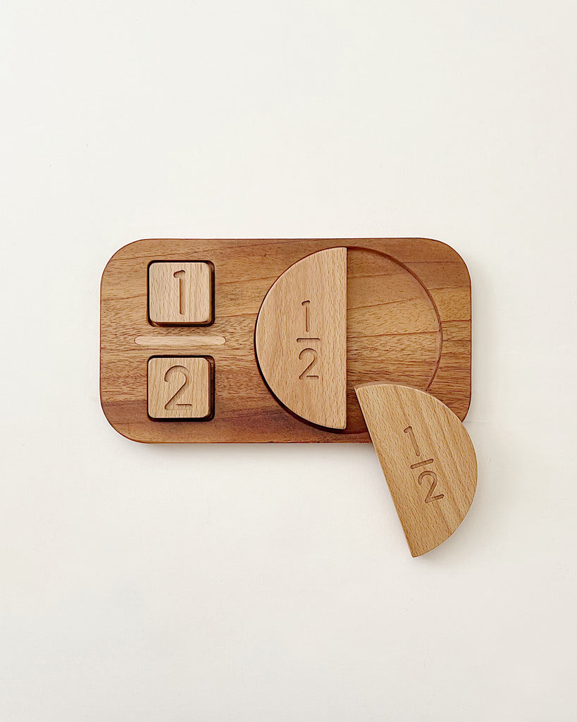 A Wooden Fraction Puzzle - Made in USA on a white background, designed for preschoolers, featuring pieces marked with fractions: one half, one quarter, and one quarter arranged on a rectangle base.