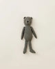 A Maileg Teddy Dad made of soft linen in a grey fabric is laid out on a plain white surface. The bear has simple stitched facial features, offering a vintage look with its minimalist design and long limbs.