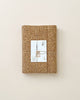 A cork-covered notebook is neatly tied with twine and features the Handmade Double Layer Wooden Puzzle - The Nest label against a light beige background. The notebook presents an eco-friendly, minimalist design.