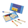 An open box of Stockmar Wax Stick Crayons Box - 12 Assorted with 16 different colors displayed alongside the box lid, which shows a colorful illustration of horses. Four non-toxic crayons are placed outside the box.