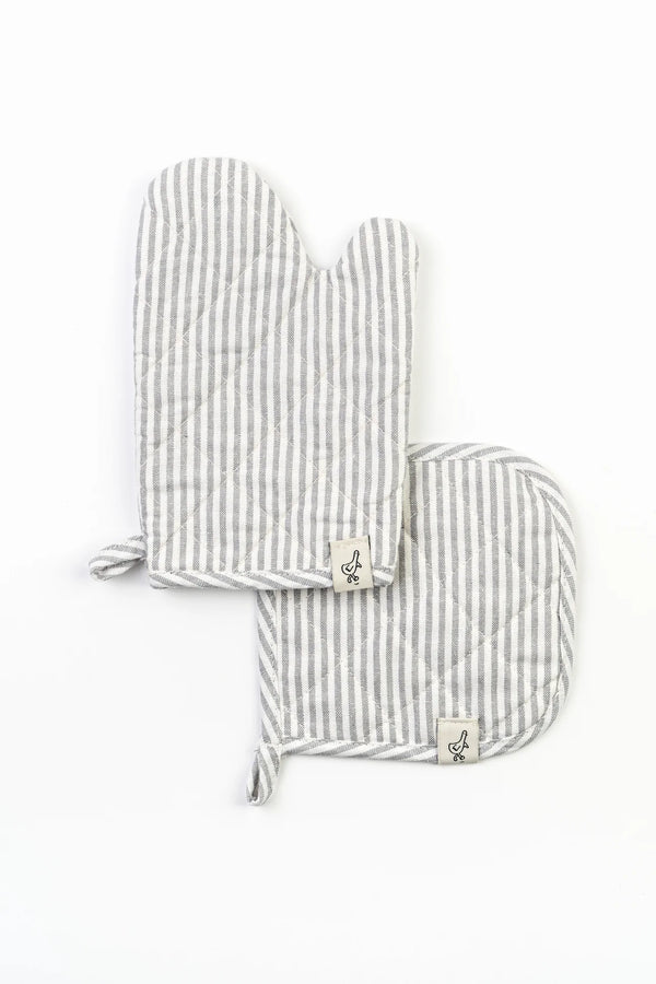 Two gray and white striped Cook Play Love oven mitt set with hanging loops and small anchor symbols on the tags, placed against a white background.