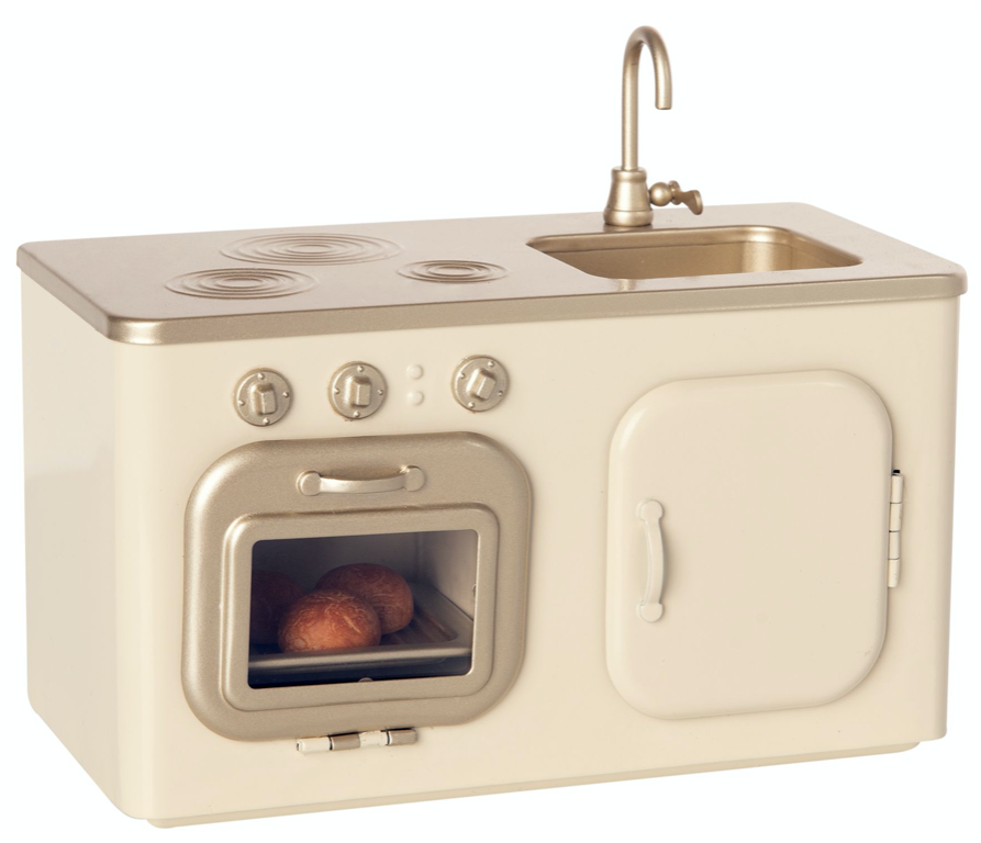 Maileg Mini Kitchen unit featuring a stove, oven with visible freshly baked buns, sink, and faucet, designed in a cream and beige color scheme.