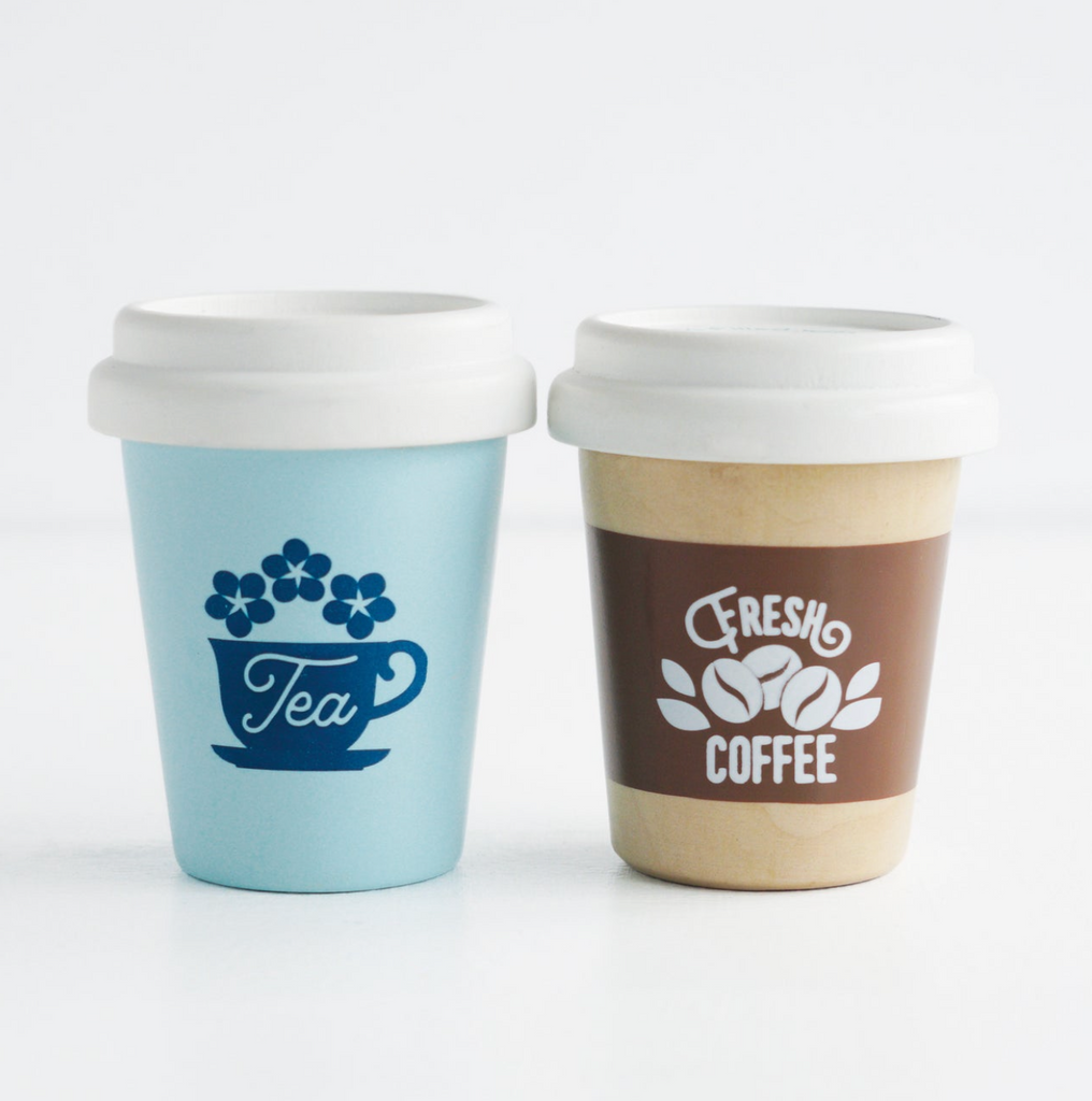 Two Wooden Coffee And Tea Cups (set) on a white background; one blue with "tea" and floral design, the other brown labeled "fresh coffee," both designed for children with white lids.