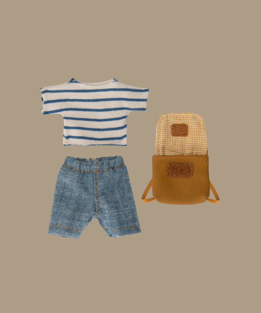 A set of children's clothing and accessories laid out on a light background, including a blue and white striped T-shirt, blue denim shorts, and an open yellow backpack with a checkered interior—perfect for Maileg Extra Clothing: Clothes & Bag for Big Brother.