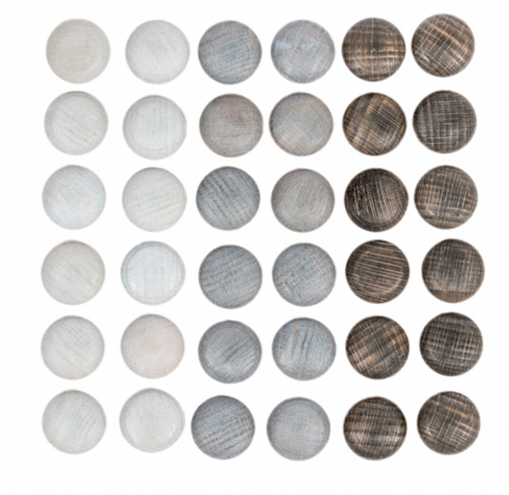 An array of 25 Grapat Mandala Stones in various shades and textures of white and gray, neatly arranged in a five by five grid on a sustainable wood background.