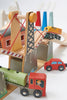 A colorful wooden Mountain View Train set featuring a modern train set, toy crane mechanism, and car on a track system, situated in a playful arrangement symbolizing a construction scene.