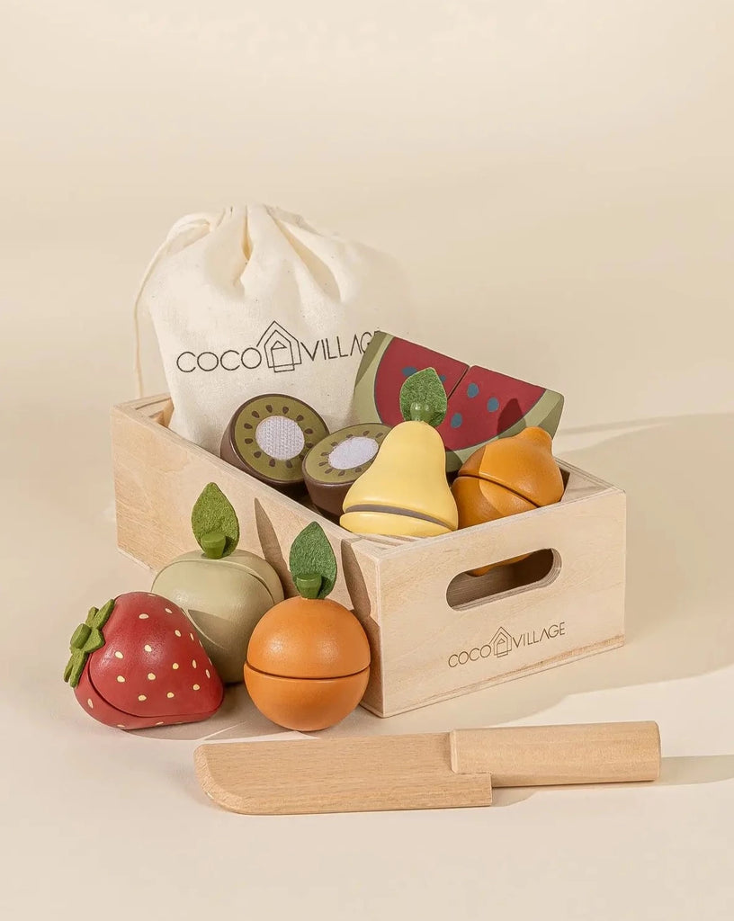 Natural color wooden crate with wooden brown kiwi, wooden red strawberry, wooden red and green slice of watermelon, wooden yellow pear, wooden orange mandarin. Also includes a canvas beige bag with string to put wooden fruits in it and a wooden natural color pretend play knife.