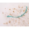 Close-up of a Meri Meri White Tulle Star Cape Costume with gold glitter star prints and a soft teal ribbon, part of a children's ballet tutu skirt.