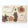 Wooden Tray Puzzle - Ocean Animals featuring ocean animal shapes: a whale, starfish, seahorse, turtle, and jellyfish, all set against a light background in this educational Ocean set.