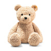 A Steiff XL Jimmy Teddy Bear, 22 Inches with a textured, light brown fur sits against a white background, looking directly at the viewer with a friendly expression. This Steiff bear features the signature "Button in Ear.