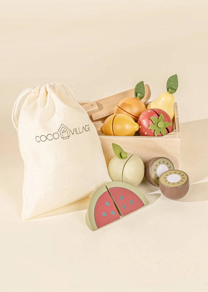 Beige canvas bag with string to store wooden fruits. Natural color wooden crate, natural color wooden pretend play knife. One wooden orange with green felted leaf, one yellow wooden pear with green felted leaf, one wooden green apple with green felted leaf, one wooden brown kiwi, and one wooden red watermelon slice.