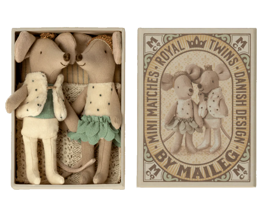 Image of a Maileg Royal Twins in Box, Little Brother and Sister containing two plush toy dogs dressed in vintage-style clothing, accompanied by a decorative packaging label with elegant text and design elements.