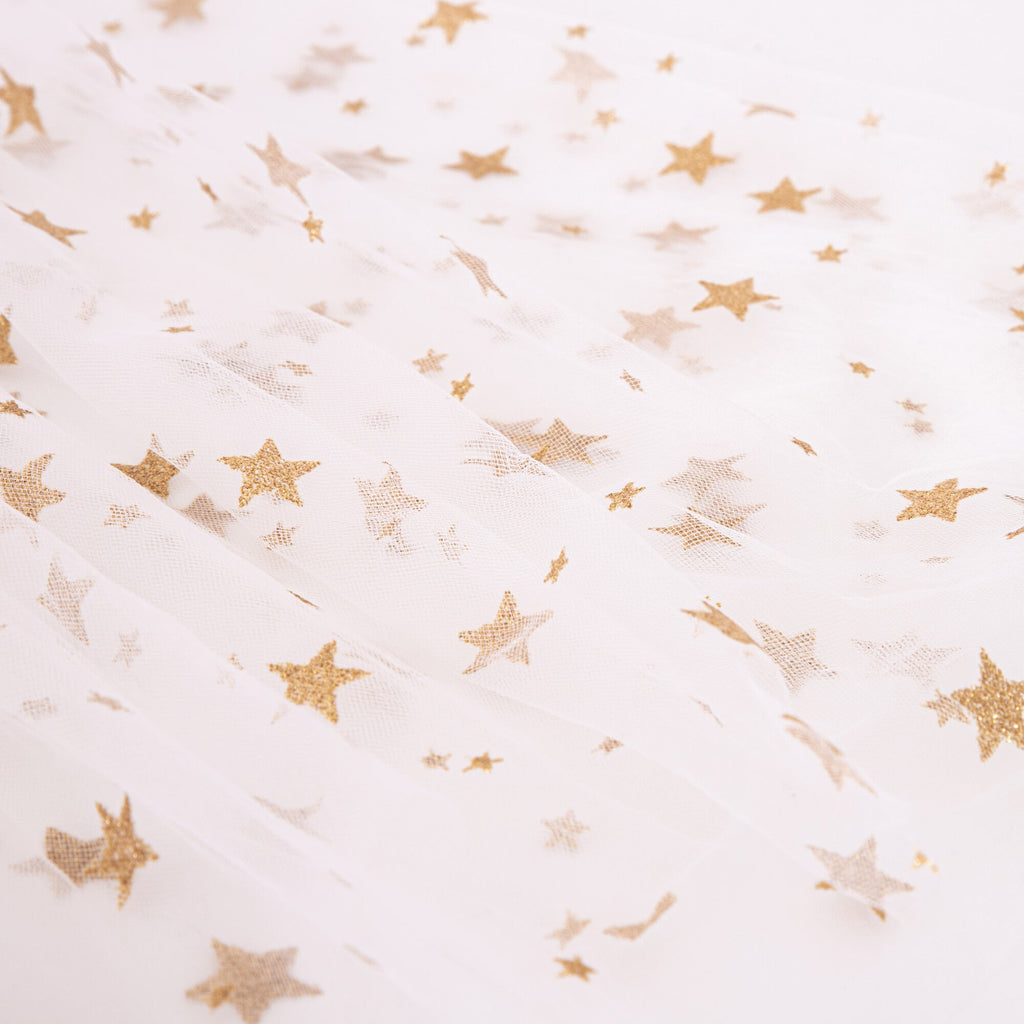 Meri Meri White Tulle Star Cape Costume adorned with scattered gold glitter stars, both small and large, on a neutral background.