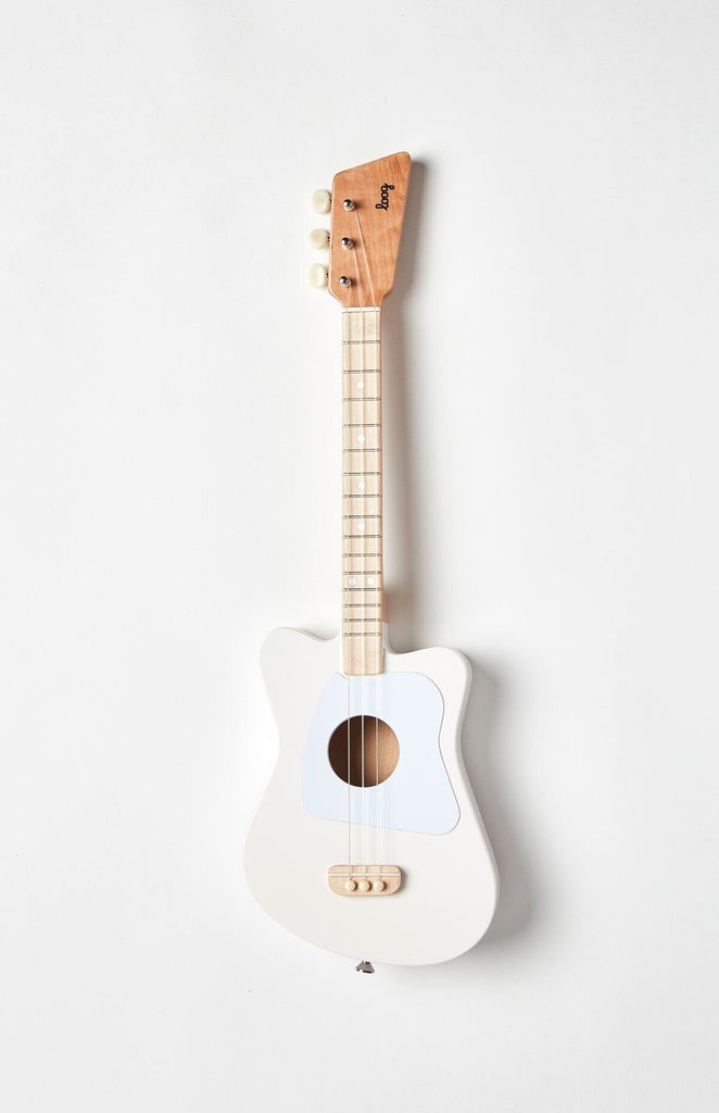 A wooden kid's guitar painted in white.