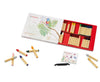 A set of 32 vibrant Stockmar Wax Stick Crayons Box - 32 Assorted displayed both in an open red box and scattered around it, with a sharpener and packaging depicting a parrot on a branch.