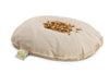 A Senger Naturwelt Cuddly Animal - Deer with a pile of barley grains on top, isolated on a white background. The toy, made from organic cotton, has a visible green label with a leaf symbol.