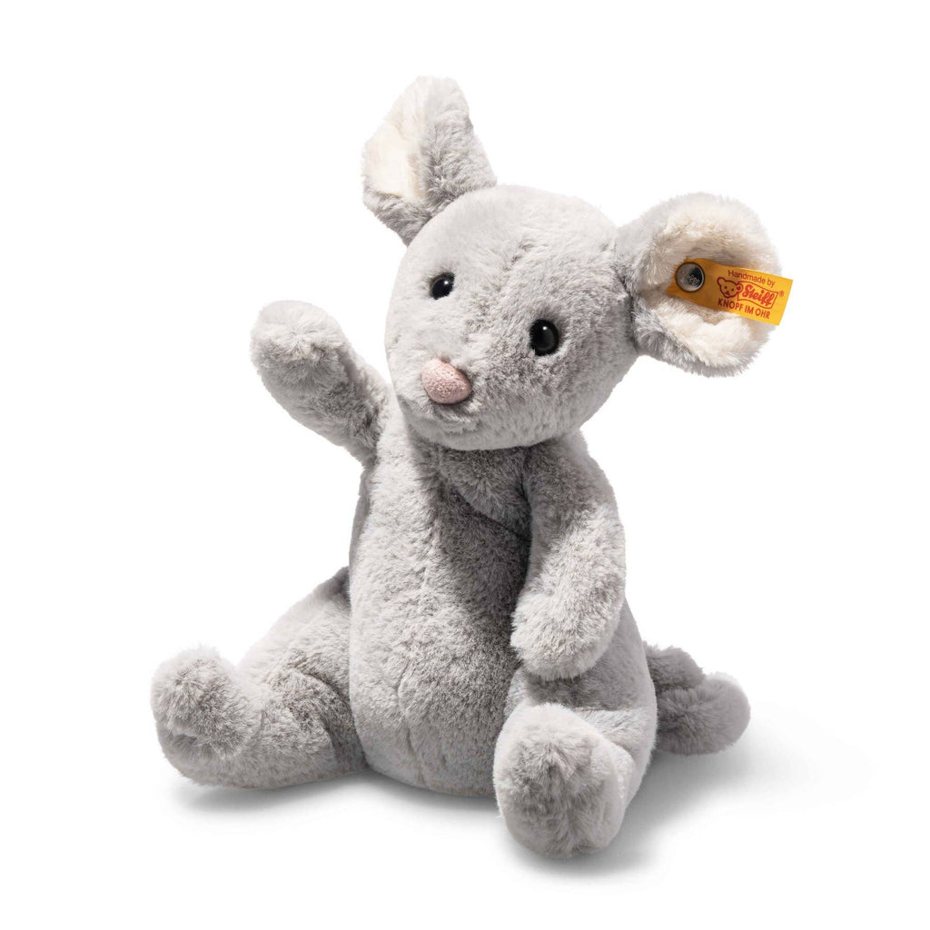 The Steiff Cheesy Mouse Stuffed Animal is a plush mouse with large ears, black eyes, and a pink nose. It sits upright with one arm raised, features bean bag stuffing, and has a yellow tag on its left ear.