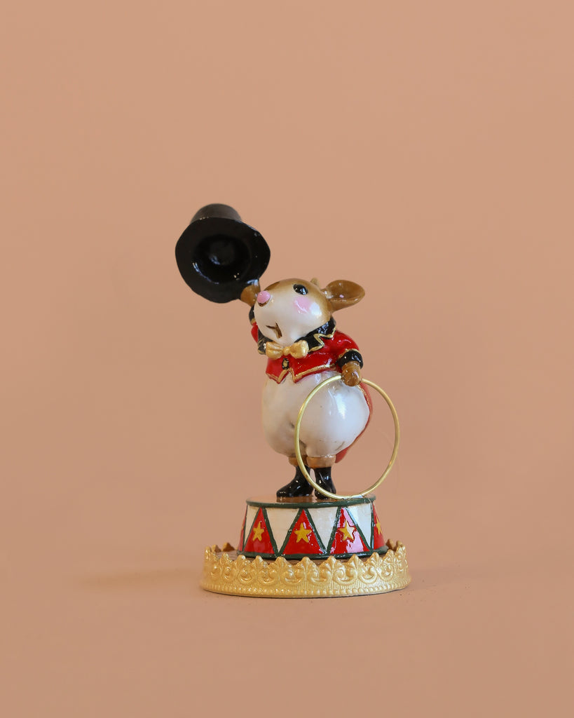 The Wee Forest Folk Tiny Collectible - Gold Rings (Not a Toy) features a mouse figurine dressed as a circus ringmaster, standing on a decorated platform and holding a black top hat and gold ring, set against a plain peach background.
