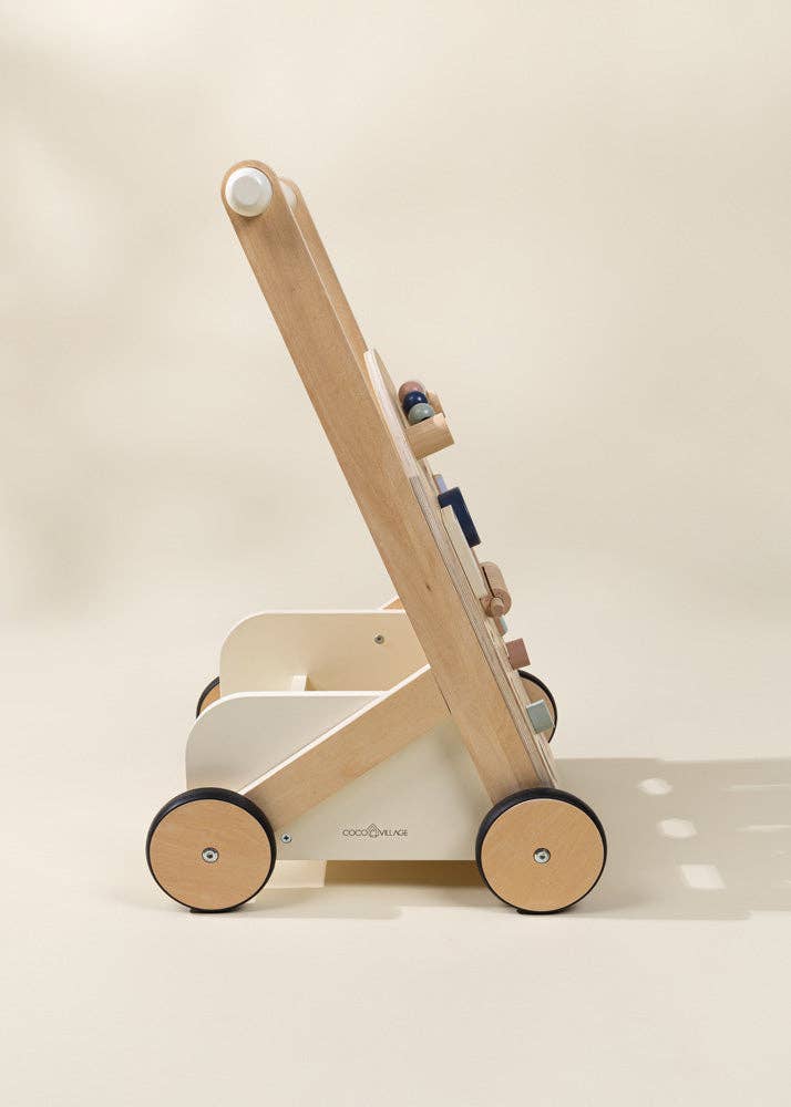 The Wooden Activity Walker features black wheels, a handle, and colorful attached blocks, shown in profile against a neutral background. Doubling as a sensory toy, this baby walker engages little ones with its vibrant colors and interactive design.