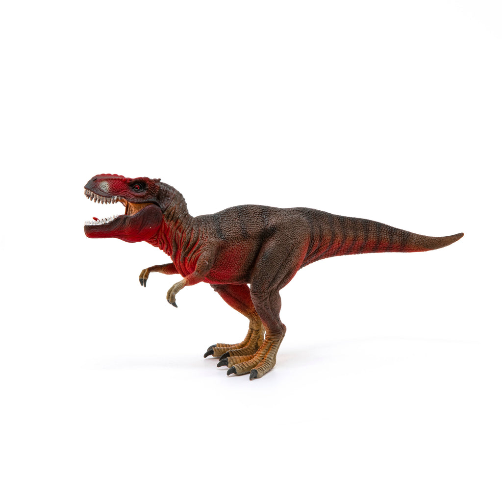 The Schleich Red Tyrannosaurus Rex Dinosaur Toy, featuring a brown body with red accents, is shown standing on a white background with its mouth open and arms raised.