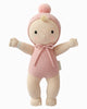 The Cuddle + Kind My First Baby (Rose) doll is hand-knit from natural cotton yarn, wears a pink romper with a matching pom-pom hat, and features embroidered eyes and a smiling face. Fair trade; ships in one week.