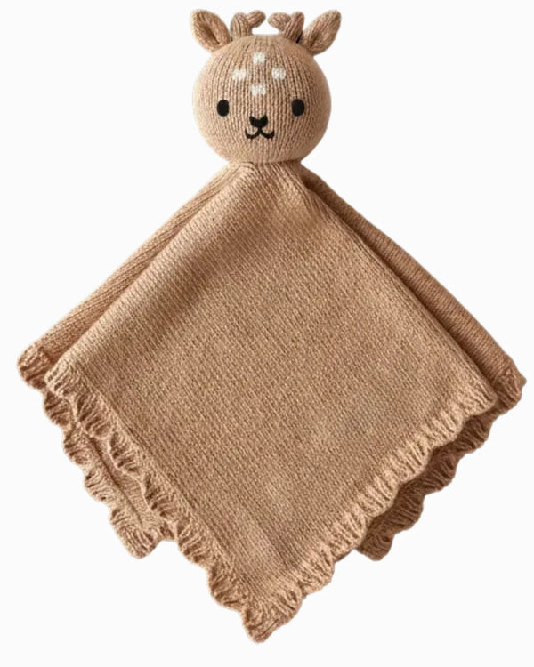The Cuddle + Kind Organic Cotton Baby Fawn Lovey is a light brown, heirloom-quality knitted blanket featuring a plush deer head with embroidered details, small antlers, and ruffled edges for extra charm.
