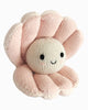 Cuddle + Kind Baby Pearl is a soft, pink plush toy shaped like an open clam shell with a smiling round face, made from heirloom-quality natural cotton yarn with embroidered black eyes and mouth.