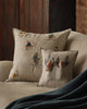 The Coral & Tusk Downhill Skiers Pillow features embroidered woodland animals skiing and in snow, adding alpine charm to your beige couch—ideal as a cozy winter cushion for inviting, ski-inspired décor.