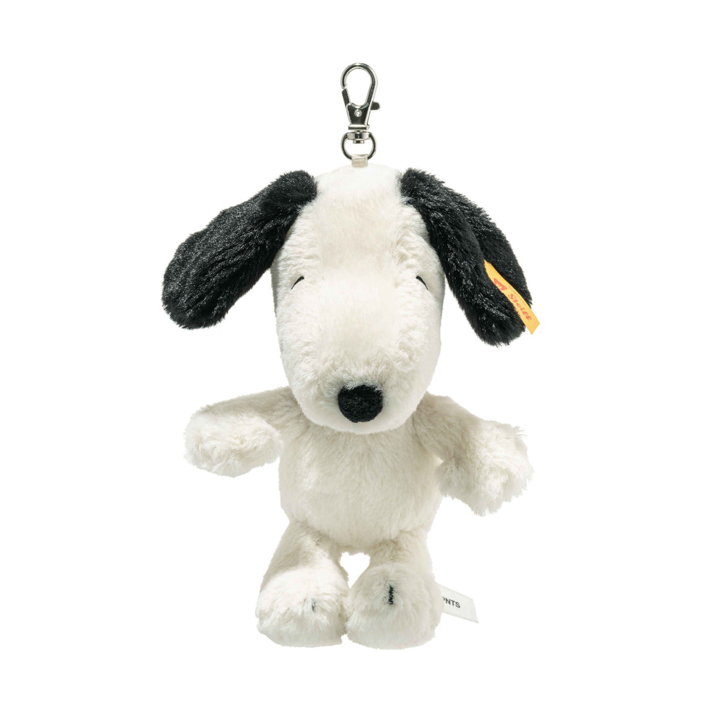 The Steiff Snoopy Keyring features a plush white dog with black ears and a black nose, styled after the beloved Peanuts character, and hangs from a sturdy metal clip.