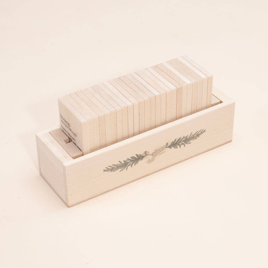 The Uncle Goose Chips - Herbs set, featuring a decorative branch design, includes a wooden box crafted from sustainable basswood, neatly holding uniform wooden blocks against a plain beige background.