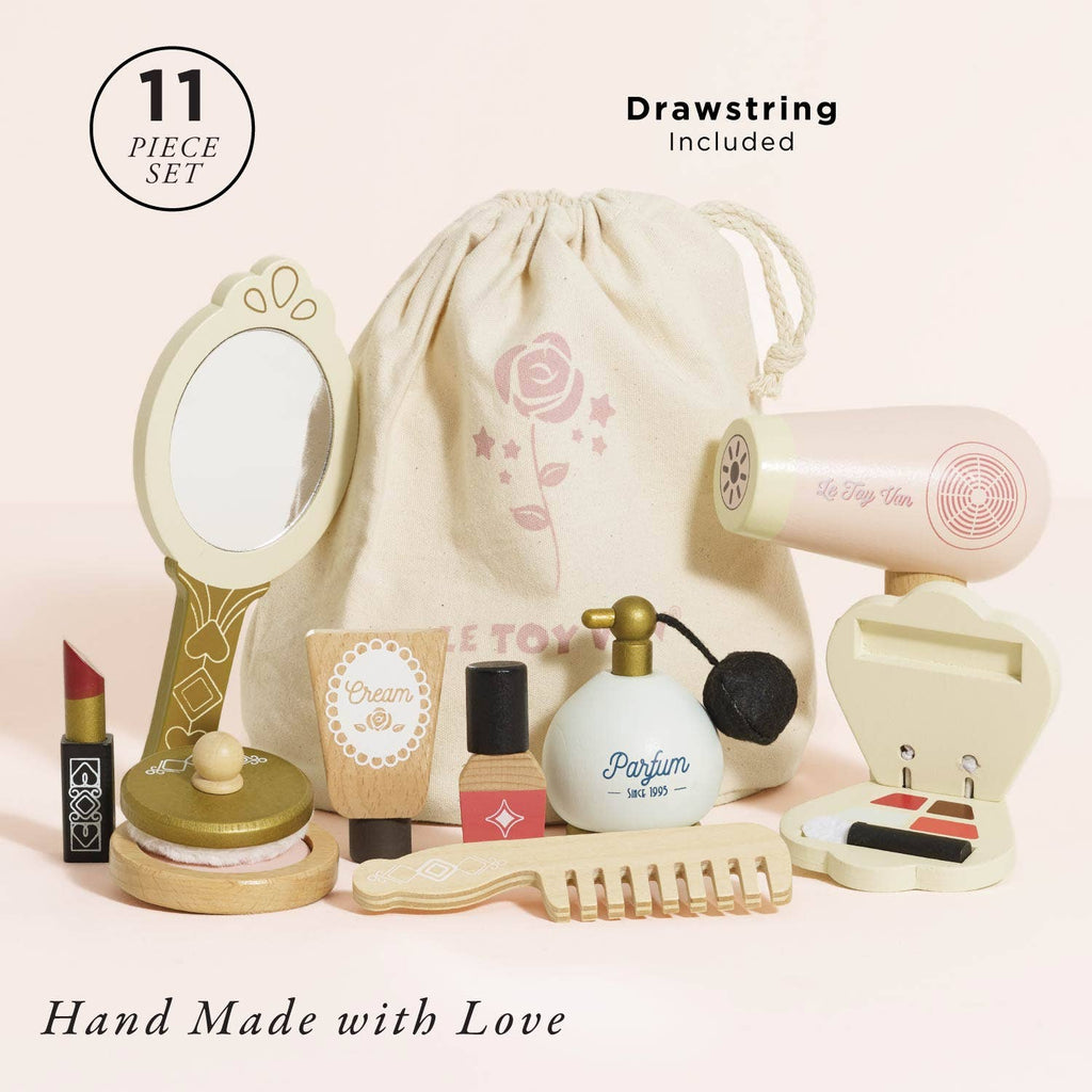 The Vanity Star Beauty Kit includes 11 wooden toy beauty accessories like a mirror, hairdryer, lipstick, and comb. This charming set comes in a rose-themed drawstring bag—perfect for pretend play. Hand made with love.