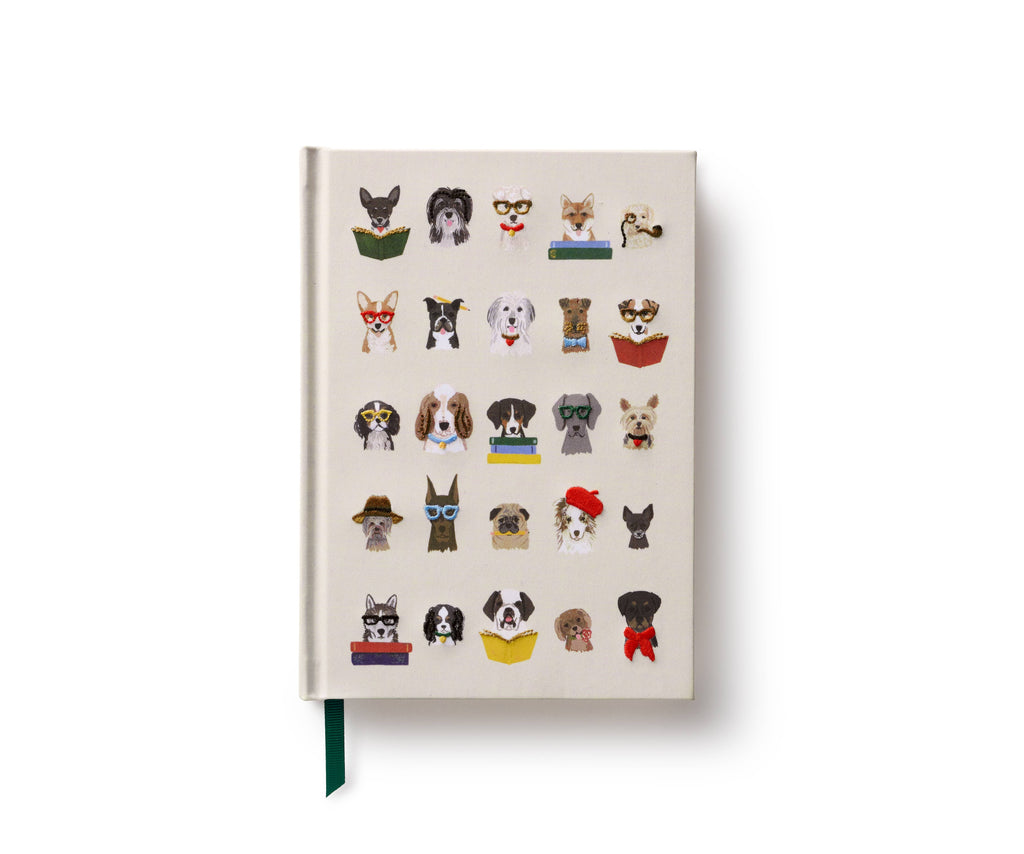 The Studious Dogs Embroidered Journal features a white cover with embroidered dogs in glasses, hats, and bowties—some reading books. This personal diary includes a green ribbon bookmark and is shown on a white background.