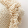 Close-up of a textured Cuddle + Kind Sawyer The Lion - Large fabric with frayed edges, exhibiting a detailed weave pattern and soft, fluffy fringes.