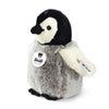 The Steiff Flaps Penguin is a plush chick with soft gray and white fur, black beak and eyes, Steiff tags on wing and chest. This collectible stuffed animal stands upright, making it perfect for cuddling or display.