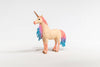 The Schleich Marshmallow Mare Unicorn is a limited edition figurine featuring a golden horn and a pink-and-blue glittery mane and tail. It stands on a white surface against a plain white background, making it a delightful addition to any Schleich unicorns collection.