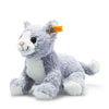 The Steiff Cassie Cat, Ice Blue is a plush cat toy with soft gray and white fur, blue eyes, a smiling face, a yellow ear tag, and is posed on all four legs.