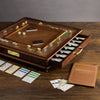 The Monopoly Luxury Edition features a brown and gold design, die-cast metal tokens, cards, money, dice, and a built-in storage drawer—beautifully displayed on an elegant wooden game board.