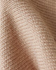 Close-up of the Cuddle + Kind Organic Cotton Baby Fawn Lovey shows its beige, ribbed knit texture and gentle folds, highlighting the detailed weave and soft, heirloom-quality design.