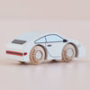 A small white wooden sports car with black and red details and light brown wheels, the No. 16 GT90 Poppy is set against a plain light pink background. This classic toy car is made in the United Kingdom.